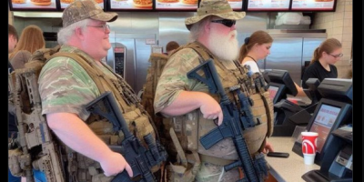 2 Heavily Armed Men In Line